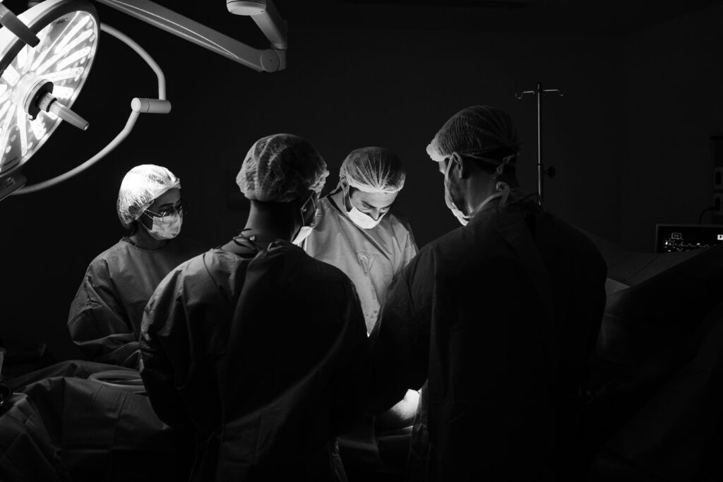 pexels-photo-13697925-13697925 A group of surgeons in an operating room, focusing intently during a procedure.